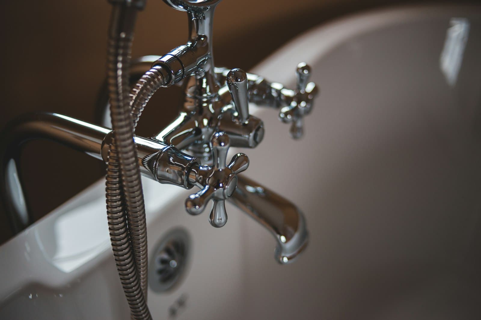 A chrome tub filler against a white enamel bath